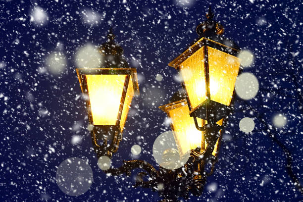 istock Street lamp post at night time in the snowing time 1211145431