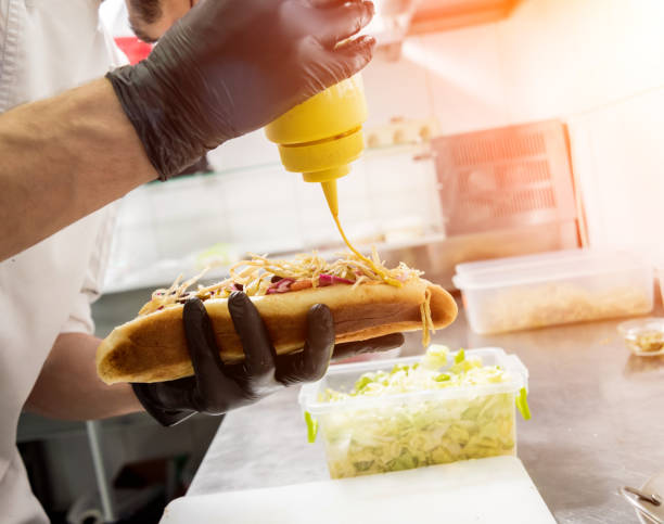 istock The chef cooking hot dog on a grill. Restaurant. 1211148457