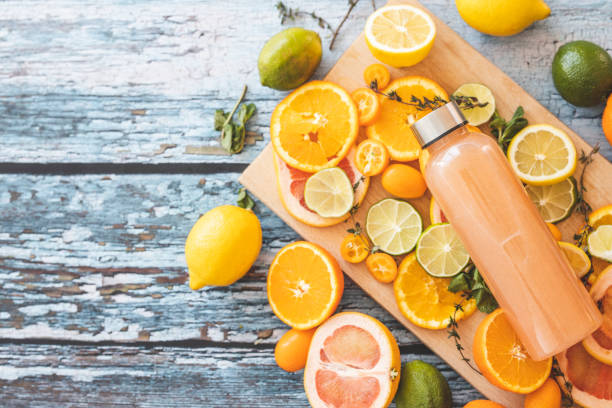 istock Grapefruit juice and slices of citrus fruit on cutting board 1211148517