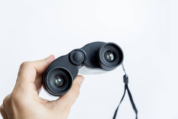 istock Female hand holds theater binoculars isolated on a white background. 1211149670