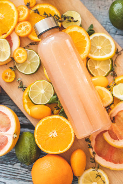 istock Grapefruit juice and slices of citrus fruit on cutting board 1211150041
