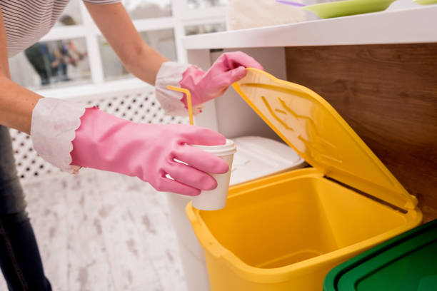 istock Young girl sorting garbage at the kitchen. Concept of recycling. Zero waste 1211153584