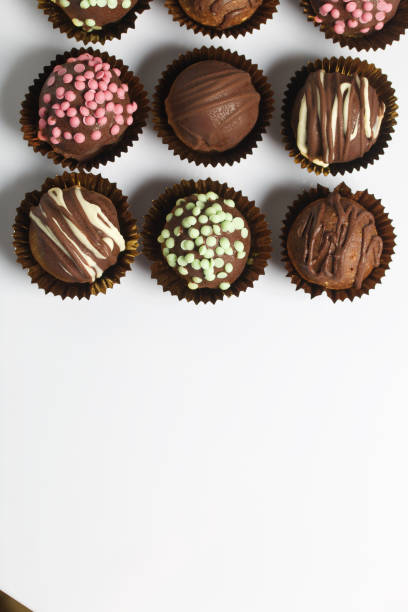 istock Chocolate Potato Cake. Some decorated with sprinkles, others with chocolate. On white background. 1211155683