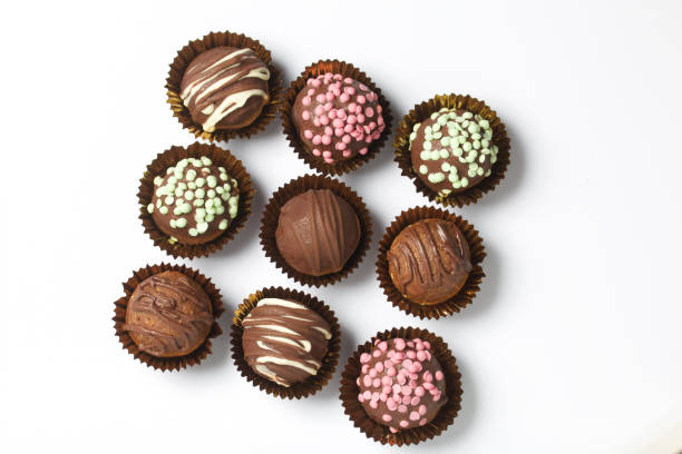 istock Chocolate Potato Cake. Some decorated with sprinkles, others with chocolate. On white background. 1211155701