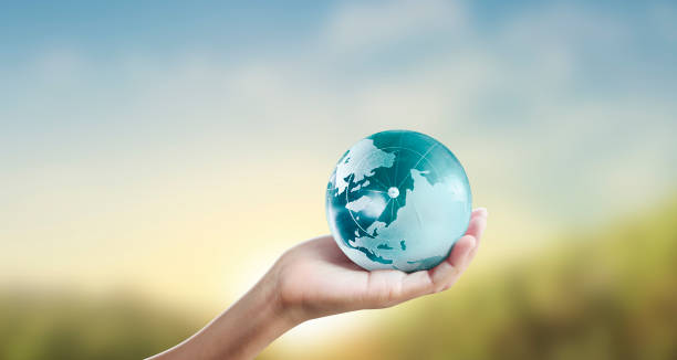 istock Globe ,earth in human hand, holding our planet glowing 1211156173
