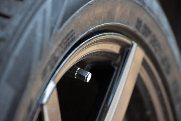 istock metal tyre valve on car wheel. 1211157471