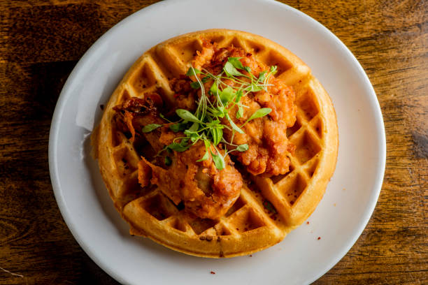 istock Chicken & waffles. Classic American Diner Style Breakfast or Brunch menu item favorite. Crispy homemade fried chicken on top of home buttermilk waffles topped with butter and maple syrup. 1211157859