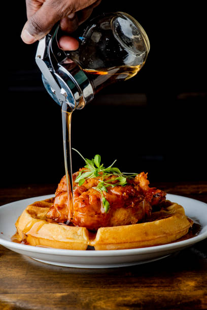 istock Chicken & waffles. Classic American Diner Style Breakfast or Brunch menu item favorite. Crispy homemade fried chicken on top of home buttermilk waffles topped with butter and maple syrup. 1211157961