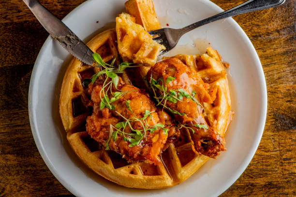 istock Chicken & waffles. Classic American Diner Style Breakfast or Brunch menu item favorite. Crispy homemade fried chicken on top of home buttermilk waffles topped with butter and maple syrup. 1211158012