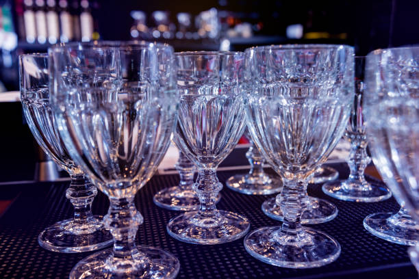 istock Wine and martini glasses in shelf above a bar rack in restaurant 1211161182