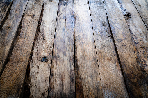 Empty rustic table background with vertical stripes. Diminishing perspective. Predominant color is brown. High resolution 42Mp studio digital capture taken with SONY A7rII and Zeiss Batis 40mm F2.0 CF lens