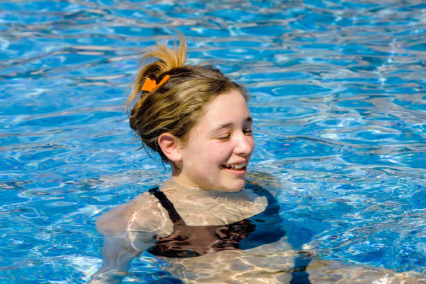 istock young woman bathing in the pool on vacation 1211163008
