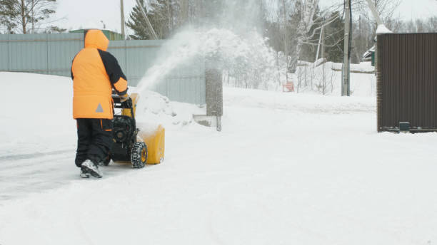 istock Man cleans snow with a snow thrower 1211163769
