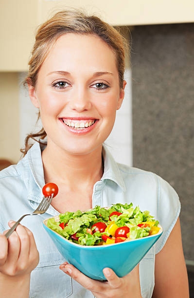 istock Happy young woman with salad 121116464