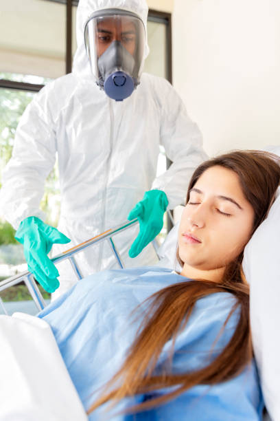 Hospital Worker Attending to Young Woman in Hospital stock photo