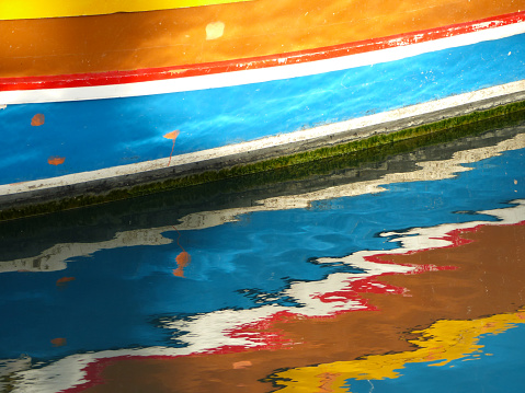 Details of the colourful traditional Maltese fishing boats, the luzzu. Marsaxlokk port, Malta