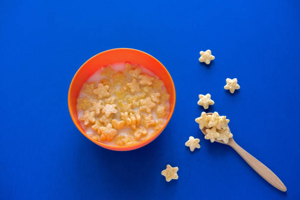 top view flat lay bowl with crunchy starry flakes on a blue background