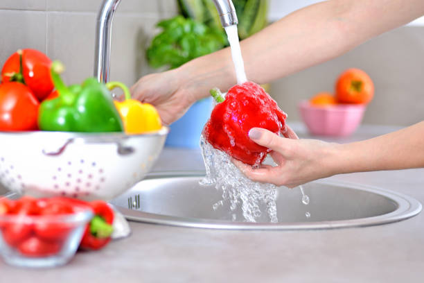 istock Washing vegetables. A woman in the kitchen. 1211170588