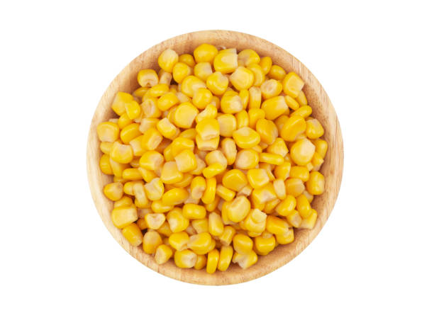 istock Canned corn seeds in wooden bowl isolated on white 1211171562