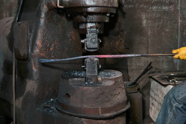 istock processing of a hot workpiece with a power forge hammer, close-up 1211171724
