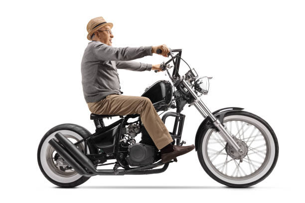 istock Excited elderly gentleman riding a custom motrobike 1211172104