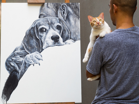 An acrylic painting a man carry beagle dog with love on white canvas while an artist carry cat at the front of his work..