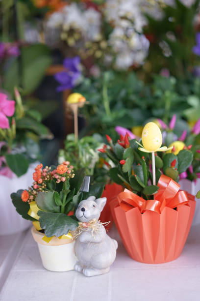 istock Flower pot. Cute and colorful flower pots with Easter bunny and Easter egg decoration. Flower shops are preparing for coming up for happy Easter event. 1211173113
