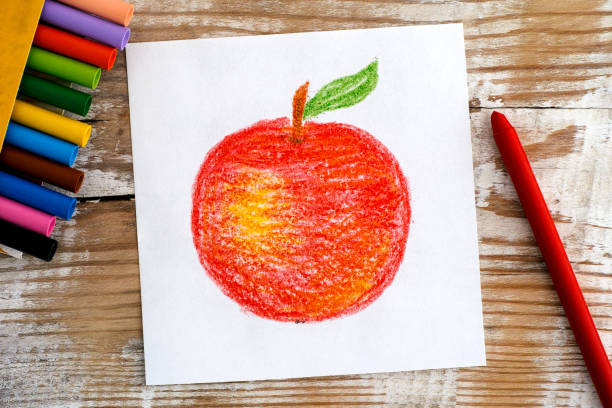 Hand drawing Red Apple with wax crayons. Wooden background.