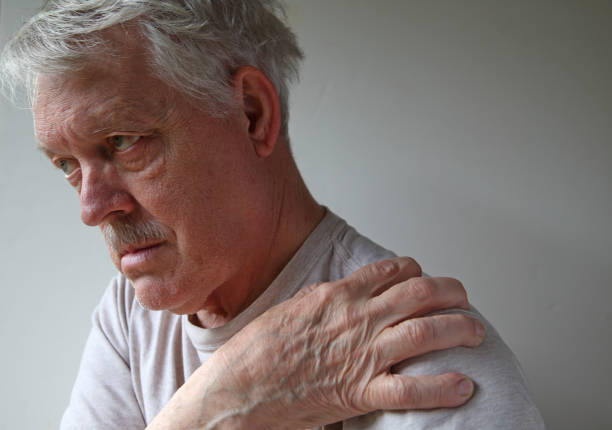 istock Aching shoulder of older male patient 1211175788