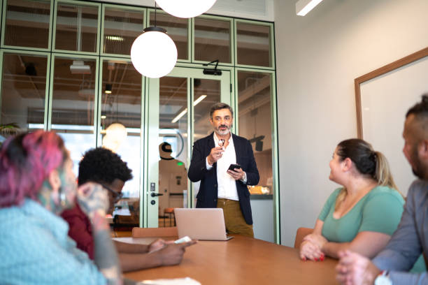 istock Business people watching a presentation at meeting 1211176036
