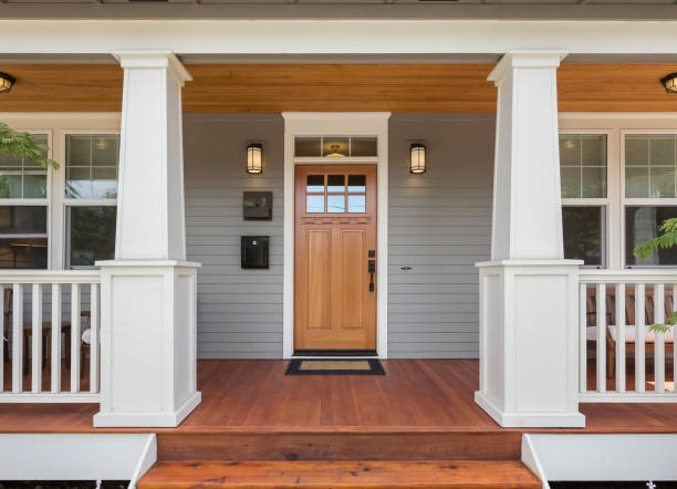 covered porch and front door of beautiful new home - residential district fotos imagens e fotografias de stock