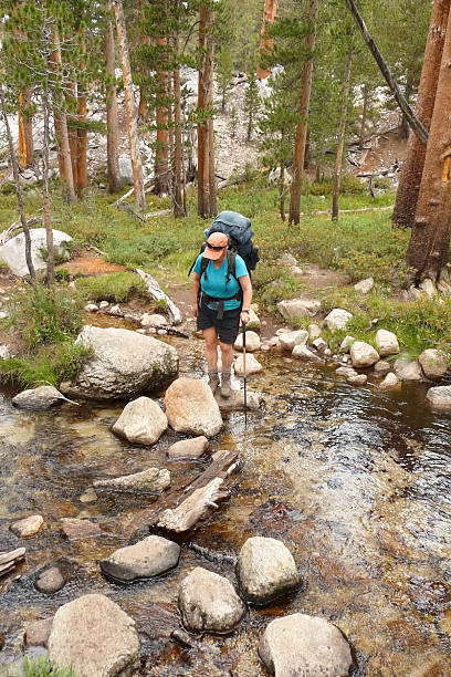 Stream Crossing Backpacker crossing stream. pacific crest trail stock pictures, royalty-free photos & images