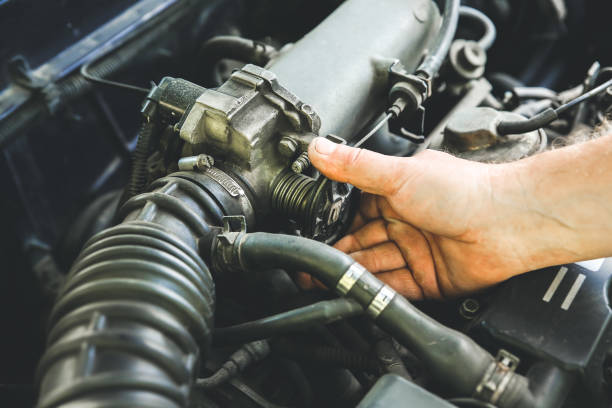 istock Man repairing old car engine. Inner details of machine. 1211188083