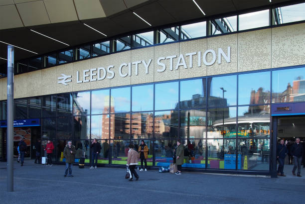 the front of leeds railway station with people standing outside in the street and walking past - leeds england uk city famous place imagens e fotografias de stock