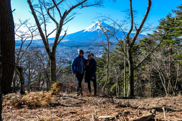 istock Japan - A couple on a hilltop with a view on Mt Fuji 1211189607