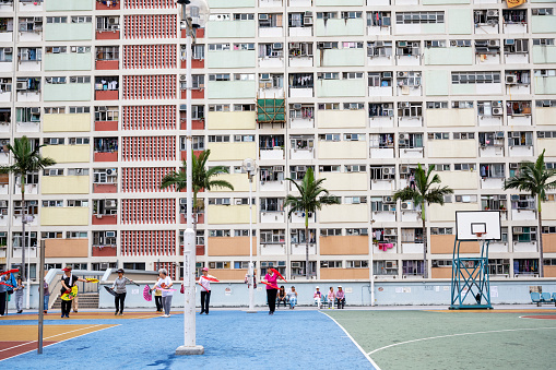 Chinese seniors practicing Tai Chi in basketball court at carpark rooftop in Choi Hung Estate (Chinese: 彩虹邨; literally: 'rainbow estate') is a public housing estate in Ngau Chi Wan, Kowloon, Hong Kong.