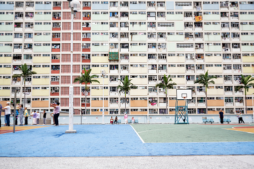Chinese seniors practising Tai Chi in basketball court at carpark rooftop in Choi Hung Estate (Chinese: 彩虹邨; literally: 'rainbow estate') is a public housing estate in Ngau Chi Wan, Kowloon, Hong Kong.
