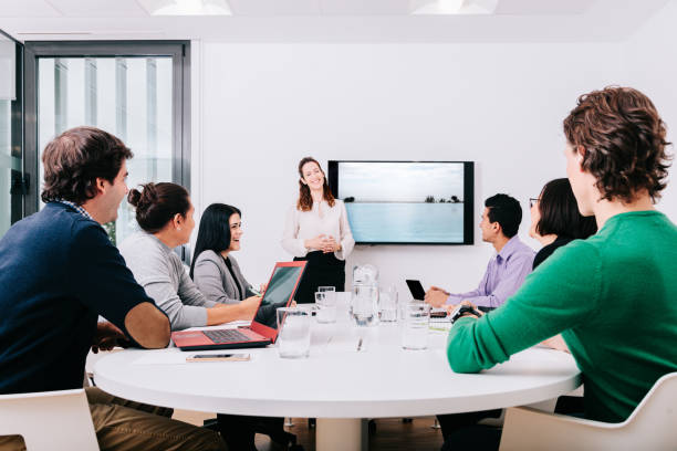 istock Group of office workers at a meeting around the boss 1211189951