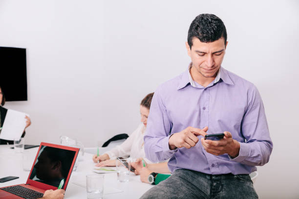 istock A businessman using his cellphone sitting at the office table 1211189969