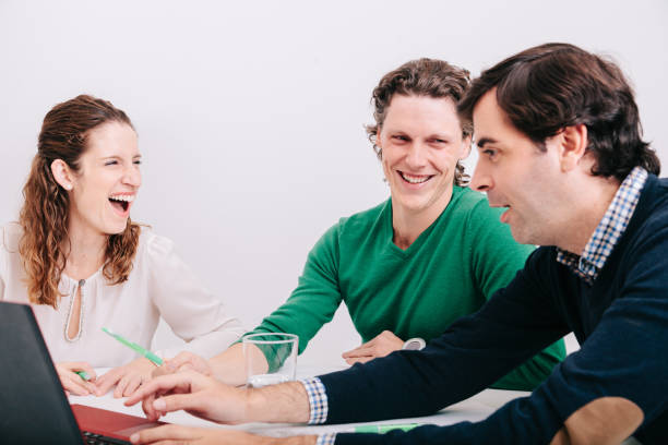 istock Group of office workers at a meeting around the boss 1211189989