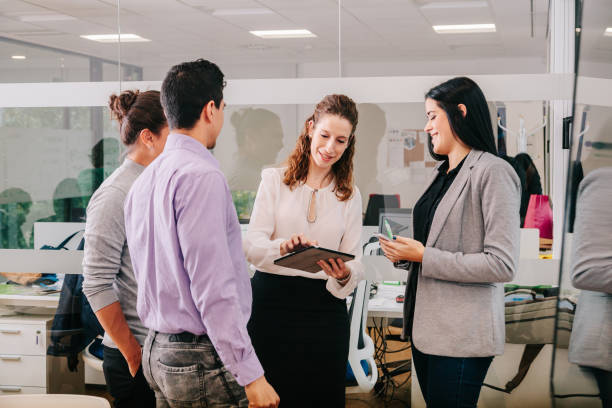 istock Group of office workers at a meeting around the boss 1211190003