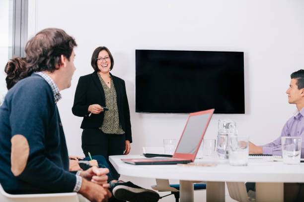 istock Group of office workers at a meeting around the boss 1211190027