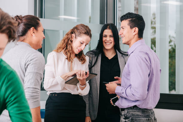 istock Group of office workers at a meeting around the boss 1211190032