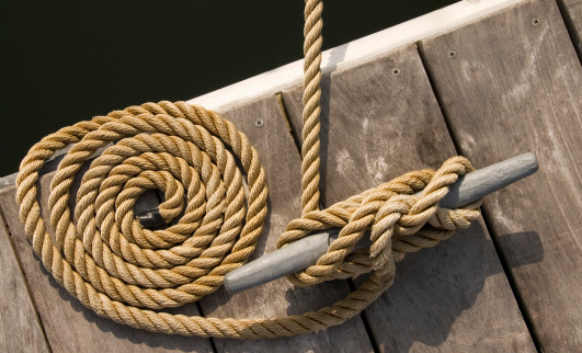 Rope tethering a boat to a dock.