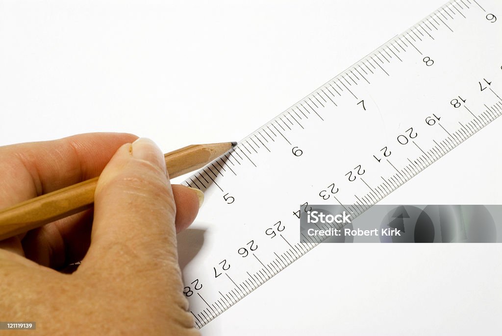Drawing a Line Drawing a line on white paper with a clear plastic ruler and pencil. Centimeter Stock Photo