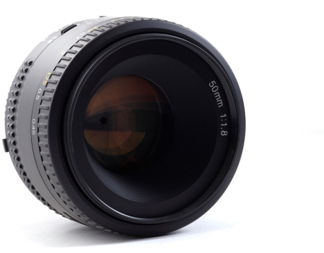 A 50mm lens for a single lens reflex camera on a white background.  The lens aperture is visible on close inspection.