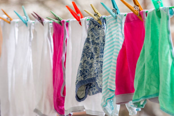istock Clothespins holding laundry on the rope 1211192422