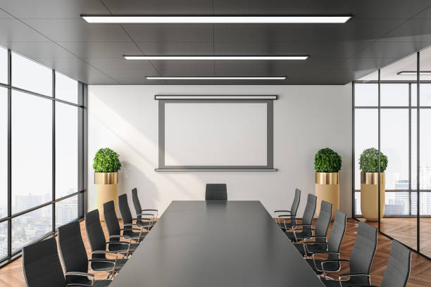 istock Contemporary conference office room with screen for projector on wall. 1211192535