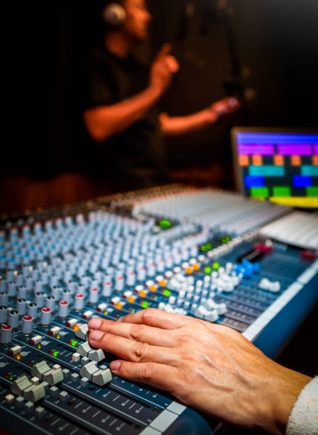 istock sound engineer recording singing voice on computer in recording studio 1211193600