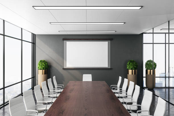 istock Contemporary conference office room with screen for projector on wall 1211193642